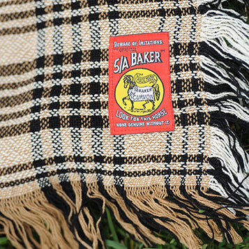 5/A Baker Original Plaid Afghan with iconic red Baker authenticity tag and classic tan, navy, and white plaid