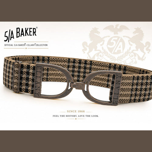 A 51A Baker Ellany collection belt with a brown and black plaid pattern, featuring dark metal D-rings and a matching buckle, displayed on a white background with brand logos.