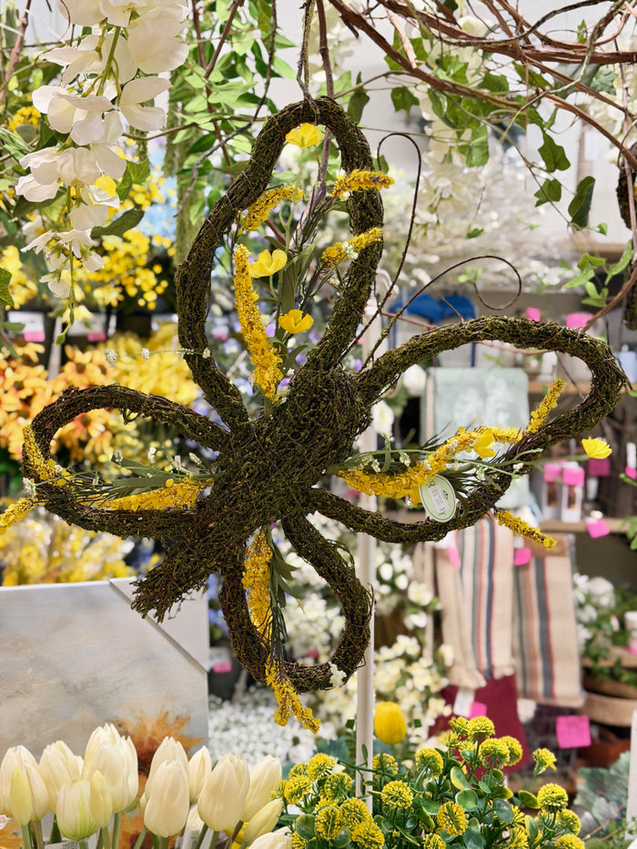 Floral twig moss butterfly wreath styled for Spring home decor from Magnolias Home Decor