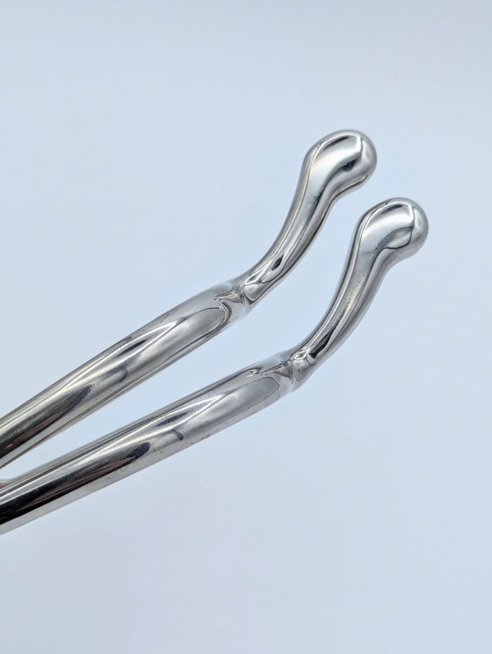 Close‑up of stainless steel swan‑neck spur tips showing the smooth, rounded ends and polished finish.