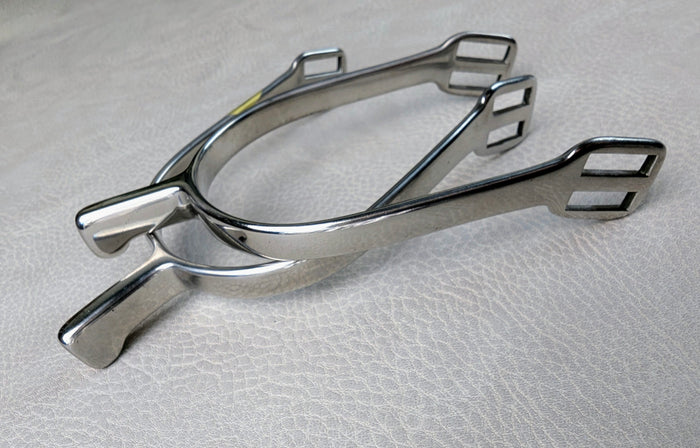 Stainless steel ladies hammerhead spurs with 25mm neck and rounded ends, shown on a light textured surface.