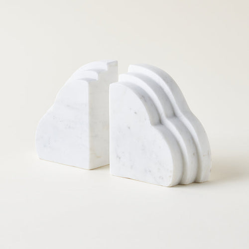 Set of 2 cloud-shaped white marble bookends on a light background. Home decor styled for a kid's room or living room bookshelf.
