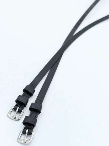 Pair of black leather spur straps with stainless steel buckles, displayed diagonally to show reinforced stitching and evenly spaced adjustment holes.