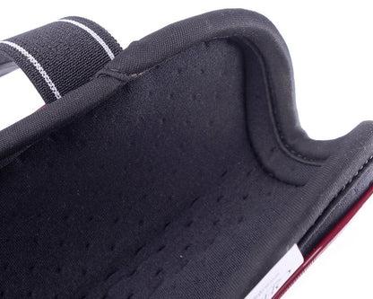 Close-up of a black tendon boot with a perforated lining on a white background