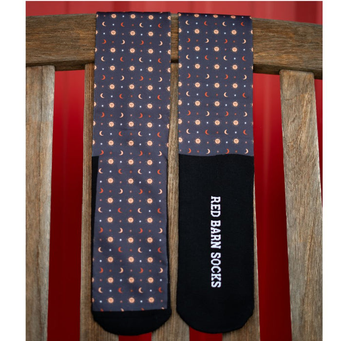 black celestial‑pattern tall socks with black Red Barn logo footbed draped over a wooden bench
