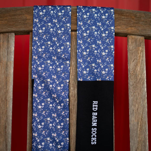 red barn socks with navy background an small flowers