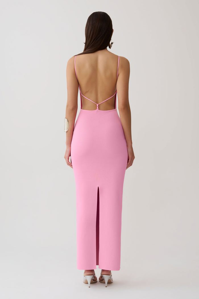 Woman wearing a strappy back bandage maxi dress.