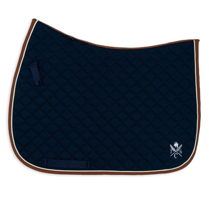 Navy blue quilted saddle pad with cognac binding and cream piping  on a white background