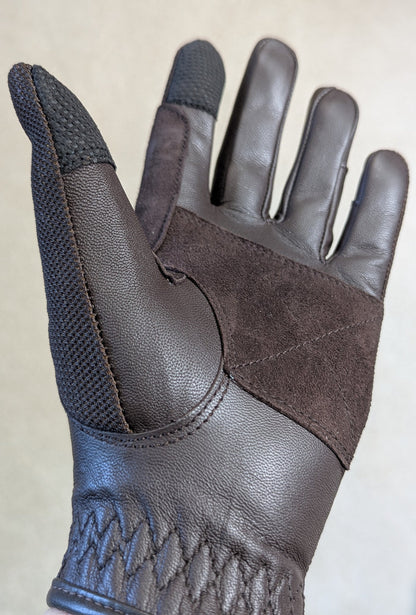Tobacco leather riding glove with brown  suede accents on a light gray background