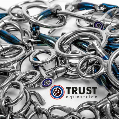 a variety of trust sweet iron blue bits with the trust equestrian logo on a white background
